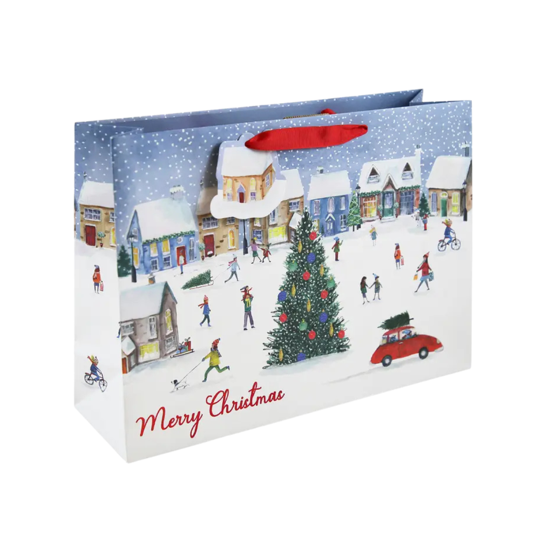 Colorful Christmas gift bag with village scene snowy streets and tree from Parte Haus party supply store in Bethesda MD