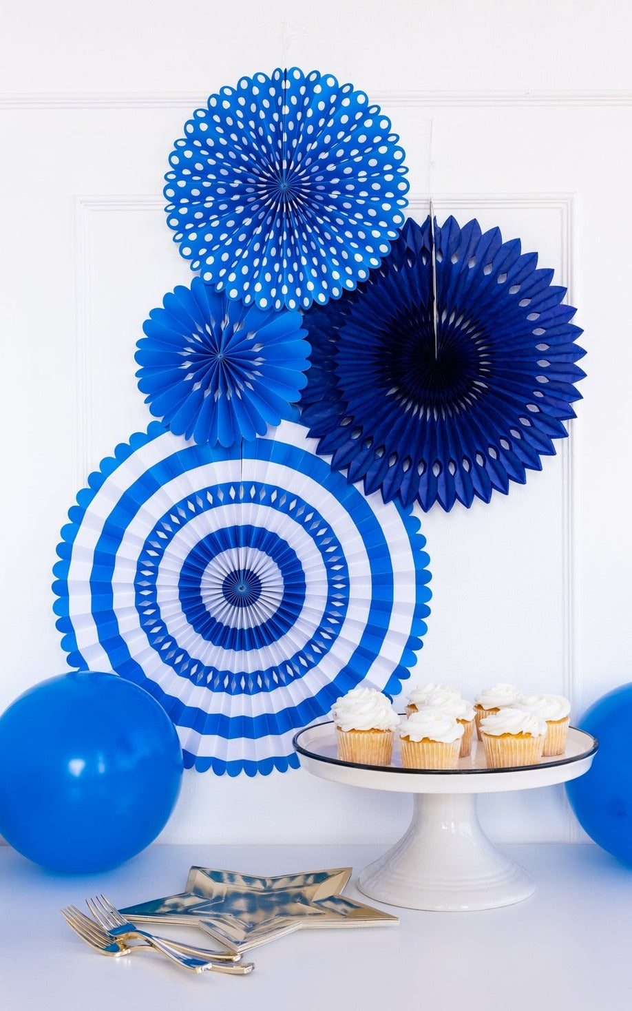 Blue paper fans and balloons dessert table with cupcakes birthday theme from Parte Haus party supply store in Bethesda Maryland