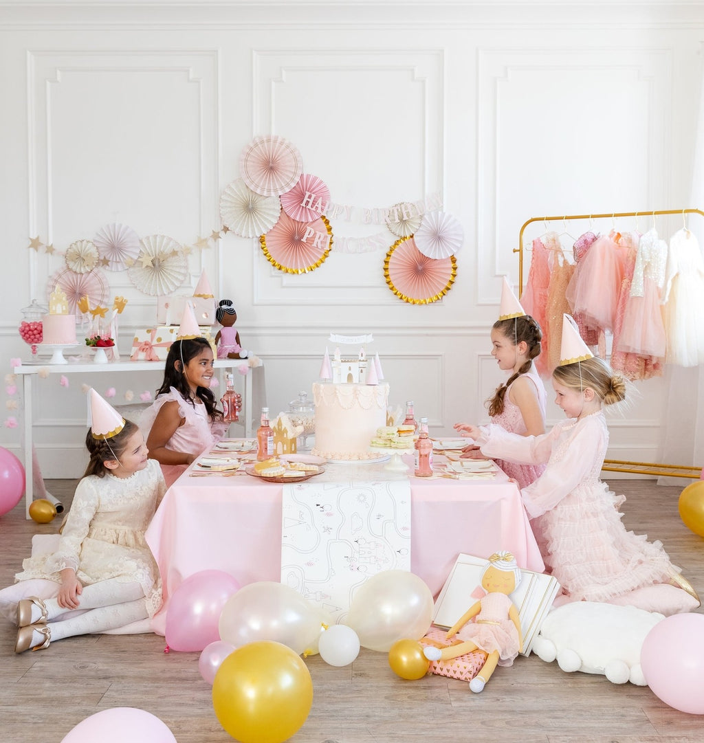 Pink and gold princess birthday table with cake balloons and girls in dresses from Parte Haus party supply store in Bethesda MD