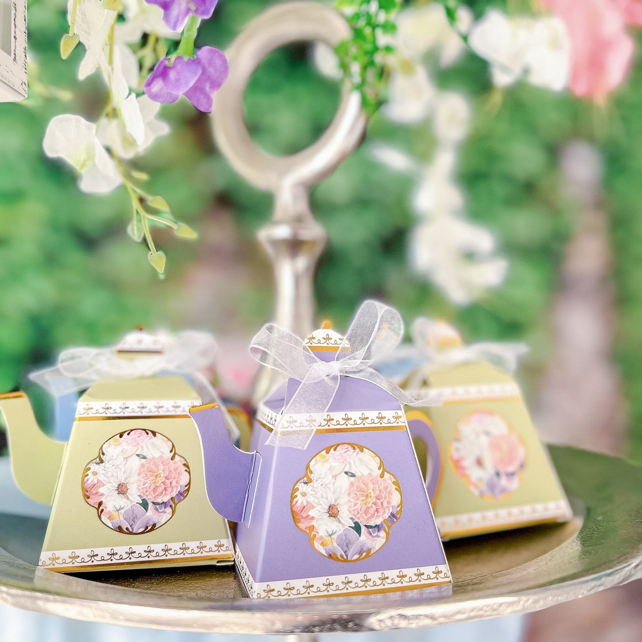 Purple and green floral teapot favor boxes with bows for tea party theme from Parte Haus party supply store in Bethesda MD