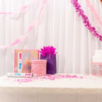 Pink and purple gift bags with table decor for gender reveal baby shower from Parte Haus party supply store in Bethesda MD