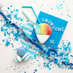 Blue snowcone sugar cookie with pastel macarons and star garland for birthday from Parte Haus party supply store in Bethesda MD