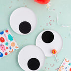 White monster eye plates and colorful monster napkins for kids birthday from Parte Haus party supply store in Bethesda Maryland