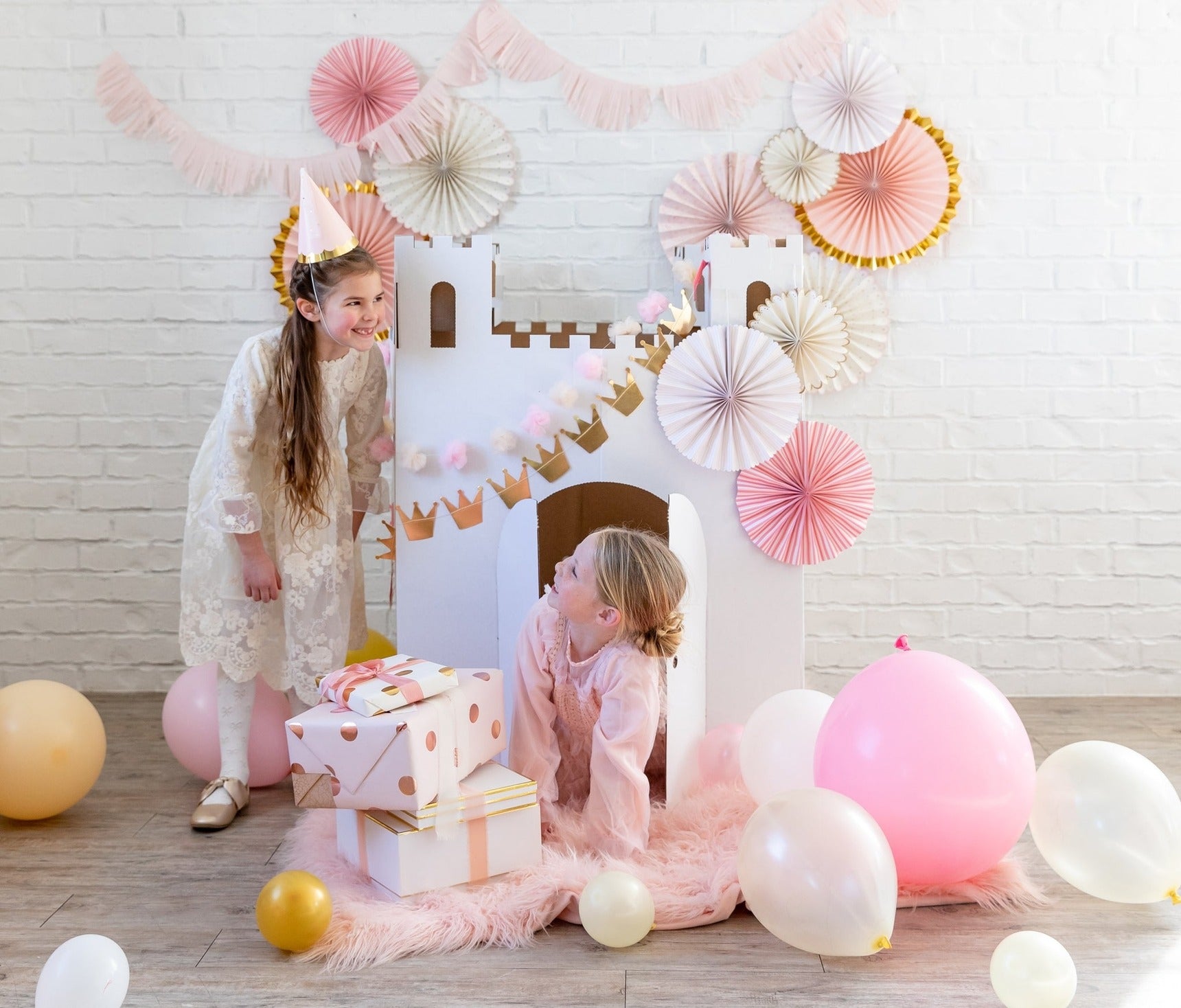Pink and gold castle backdrop kids birthday decorations with balloons from Parte Haus party supply store in Bethesda Maryland