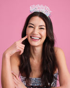 iridescent birthday girl tiara worn by smiling woman for birthday party from Parte Haus party supply store in Bethesda MD