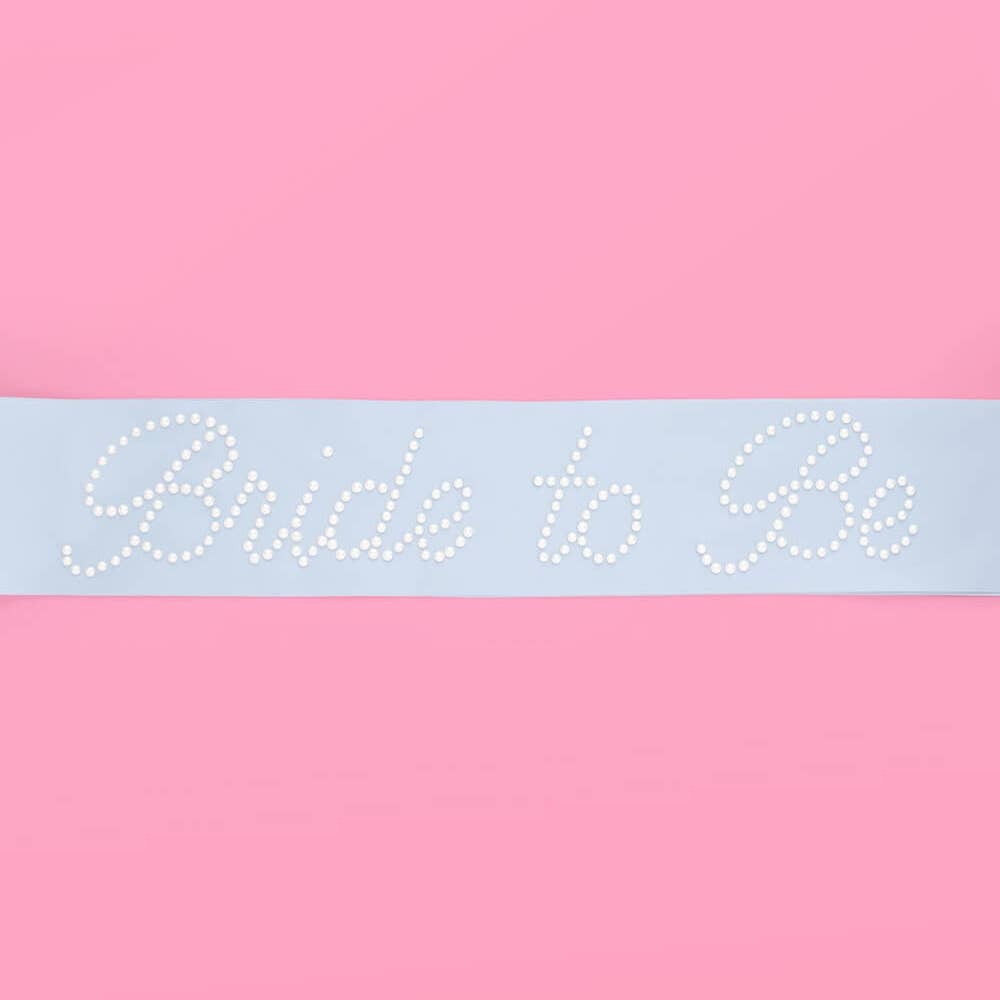White bride to be sash with pearl accents for bridal shower from Parte Haus party supply store in Bethesda MD