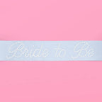 White bride to be sash with pearl accents for bridal shower from Parte Haus party supply store in Bethesda MD