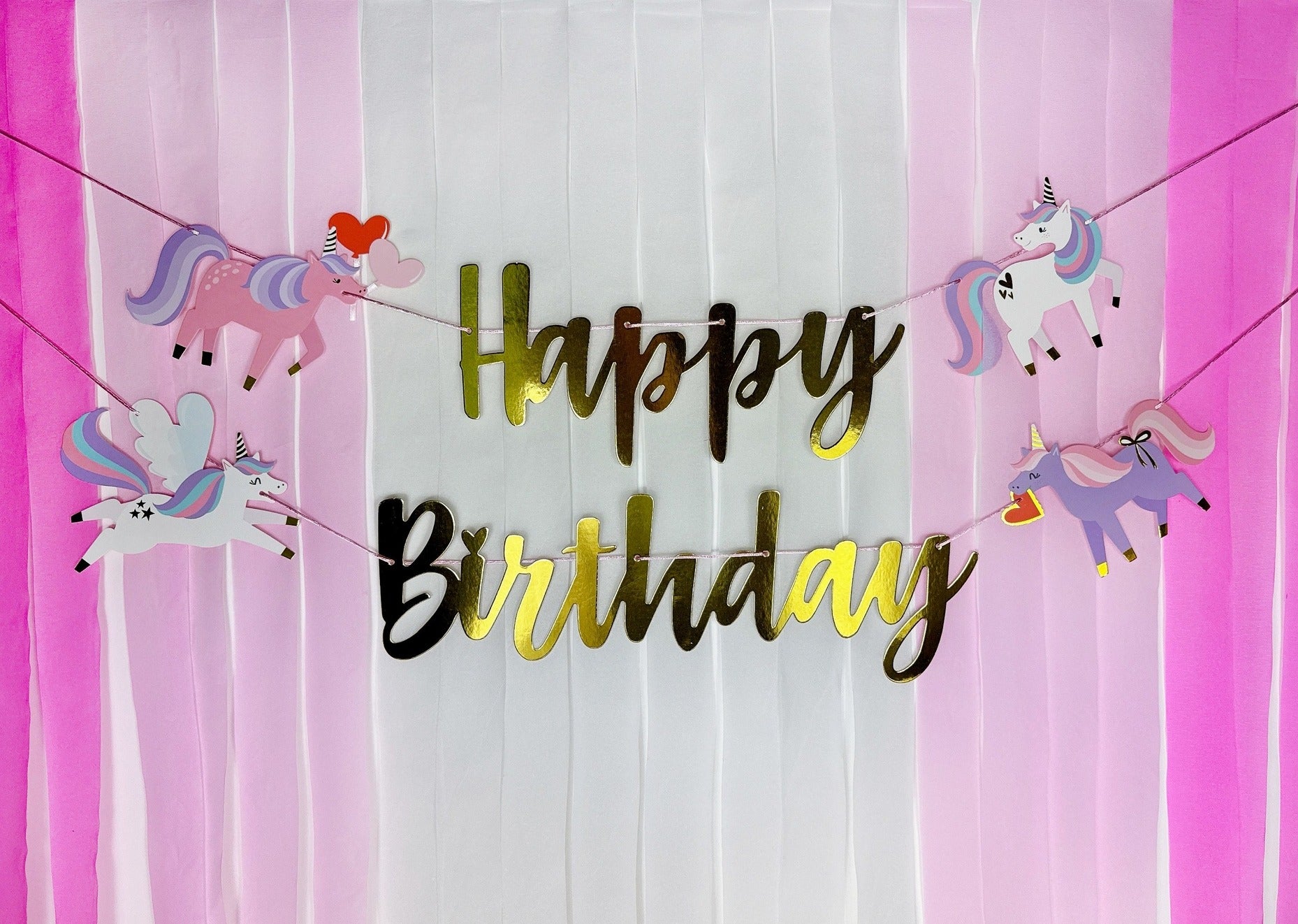 Pink unicorn birthday banner with gold happy birthday text for birthday theme from Parte Haus party supply store in Bethesda Maryland