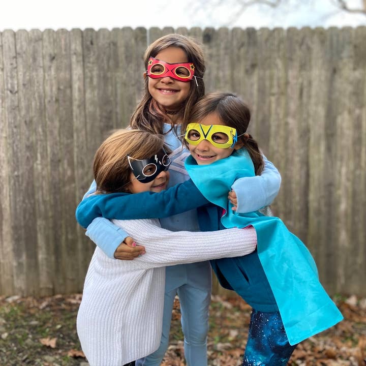 Red yellow and black superhero masks and capes kids outdoor dress up birthday theme from Parte Haus party supply store in Bethesda MD