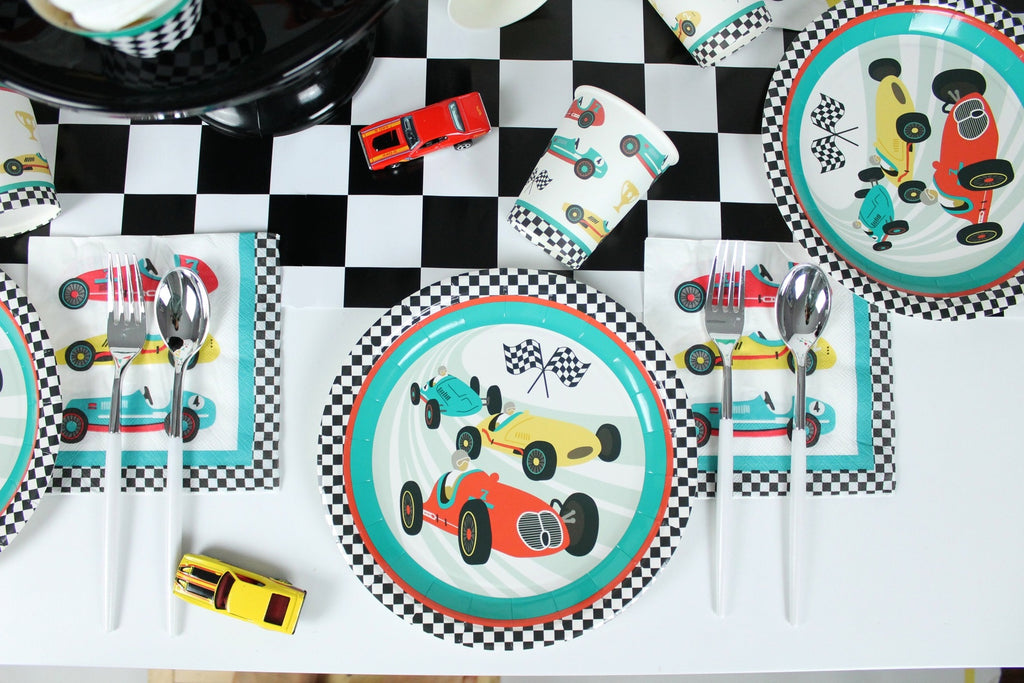 Multicolor race car plates and napkins on checkered table racing birthday theme from Parte Haus party supply store in Bethesda MD
