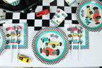 Multicolor race car plates and napkins on checkered table racing birthday theme from Parte Haus party supply store in Bethesda MD