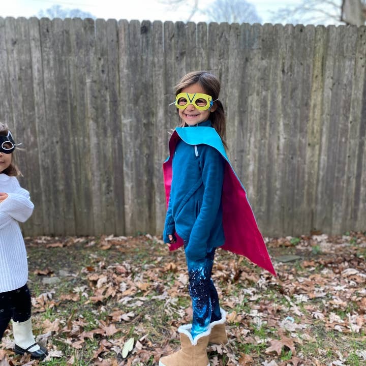 Blue and pink superhero costume for kids wearing mask outdoor birthday theme from Parte Haus party supply store in Bethesda Maryland