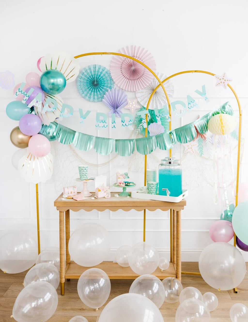 Pastel mermaid birthday decorations with balloons and banners under the sea theme from Parte Haus party supply store in Bethesda MD