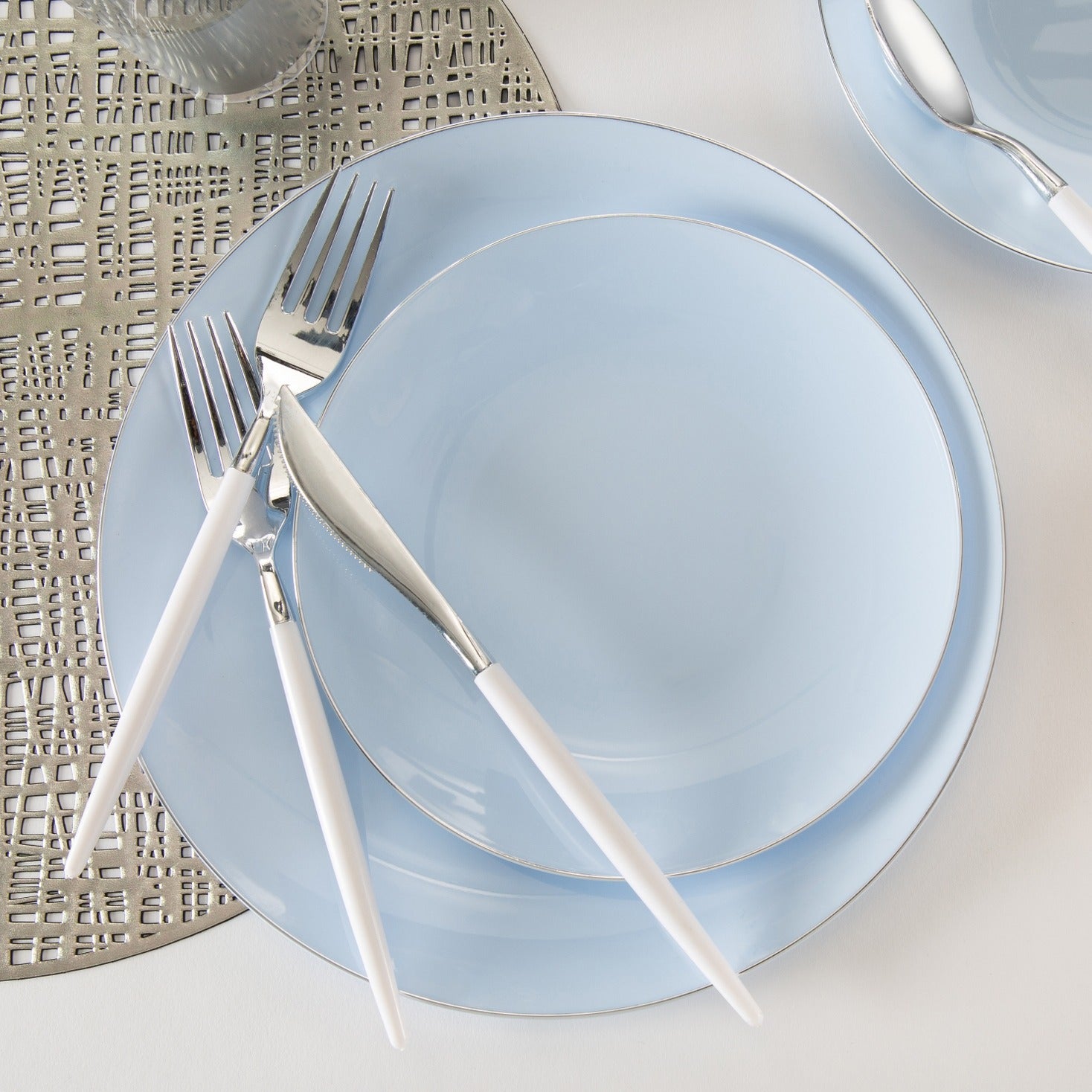 Light blue dinnerware set with white handled cutlery modern metallic placemat event from Parte Haus party supply store in Bethesda MD