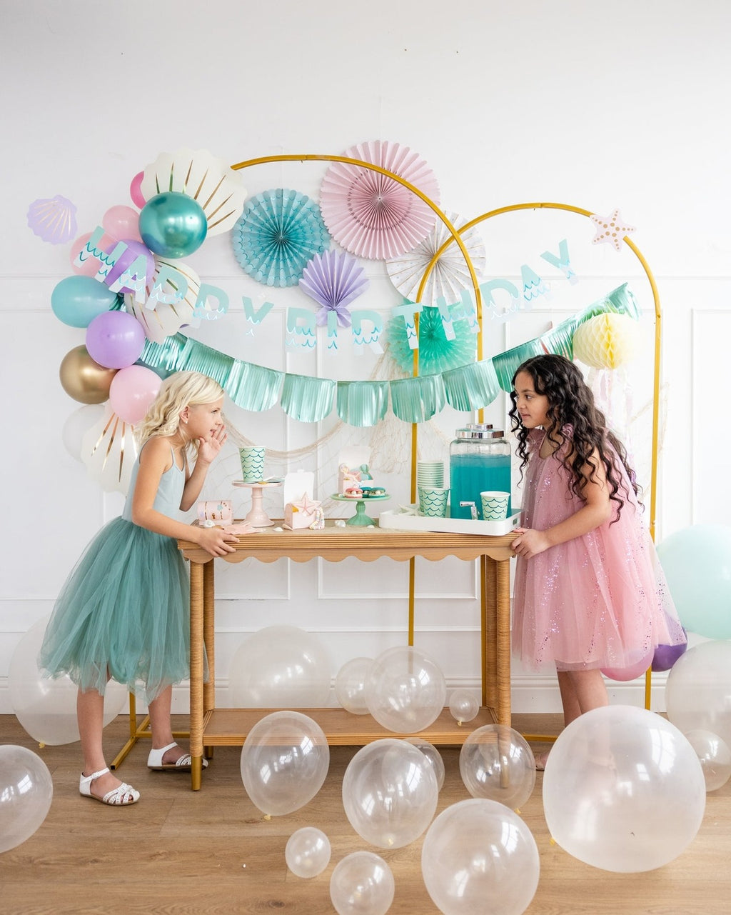 Teal and pink birthday decorations with balloons and kids from Parte Haus party supply store in Bethesda MD