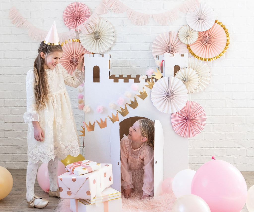Pink and white castle playhouse with girls and birthday decorations princess theme from Parte Haus party supply store in Bethesda MD