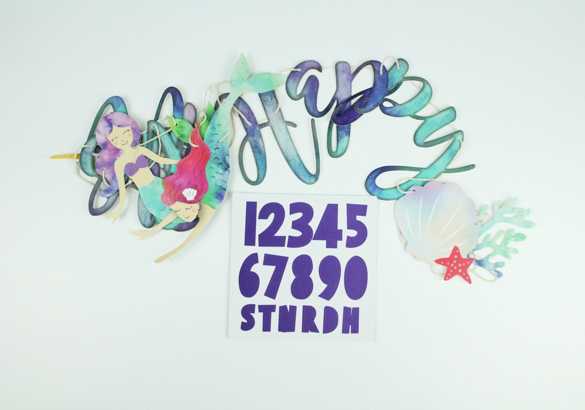 Blue and purple mermaid banner with two mermaid cutouts and seashell accents under the sea theme from Parte Haus party supply store in Bethesda MD