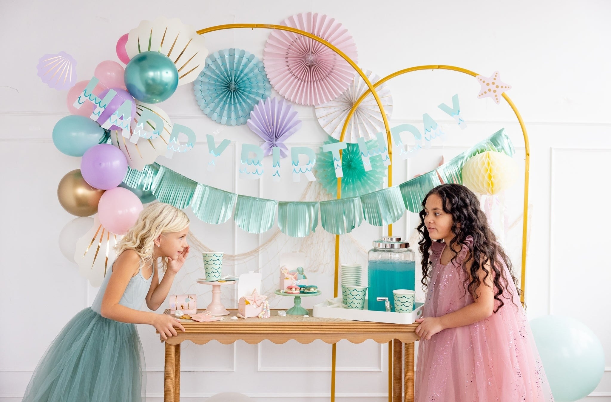 Mint and pink mermaid birthday decorations with kids and balloons from Parte Haus party supply store in Bethesda MD