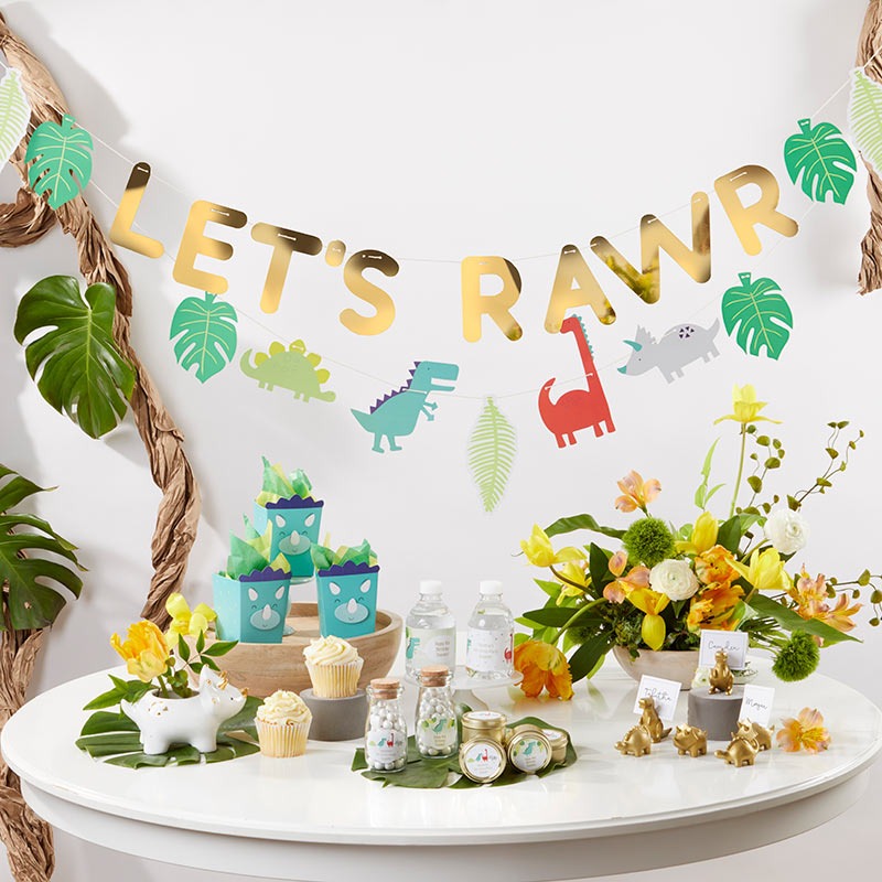 Colorful dinosaur birthday banner and table decor dinosaur theme from Parte Haus party supply store in Bethesda Maryland