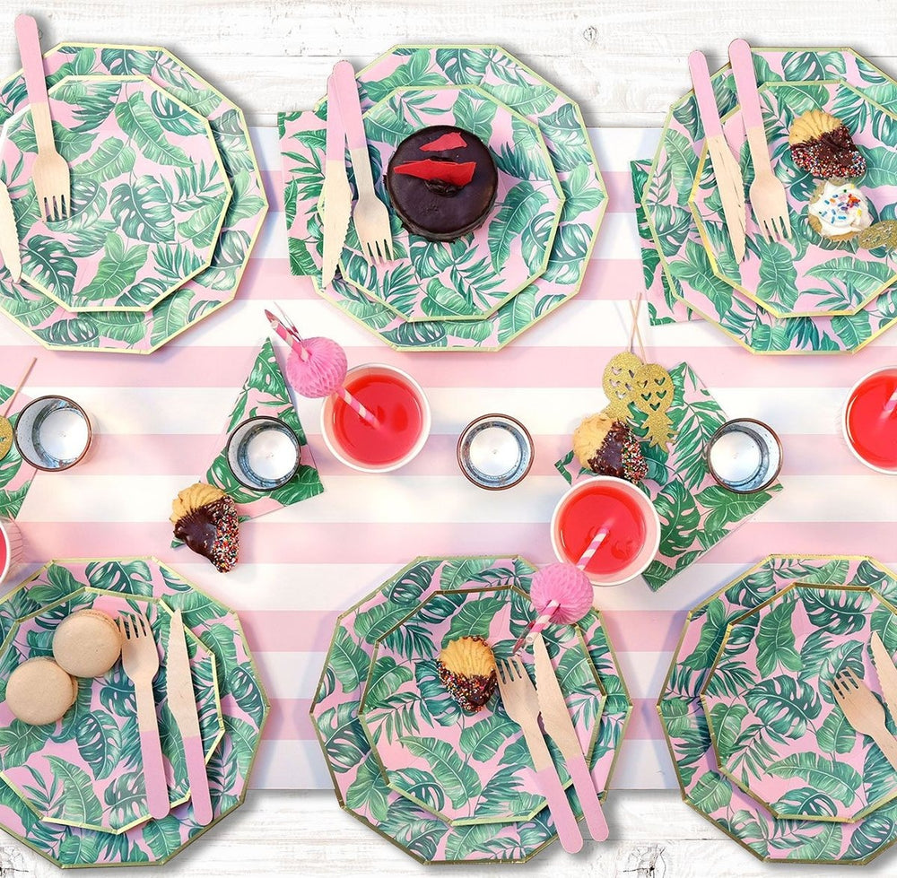 Pink and green tropical leaf plates and cups on striped table setting birthday theme from Parte Haus party supply store in Bethesda MD