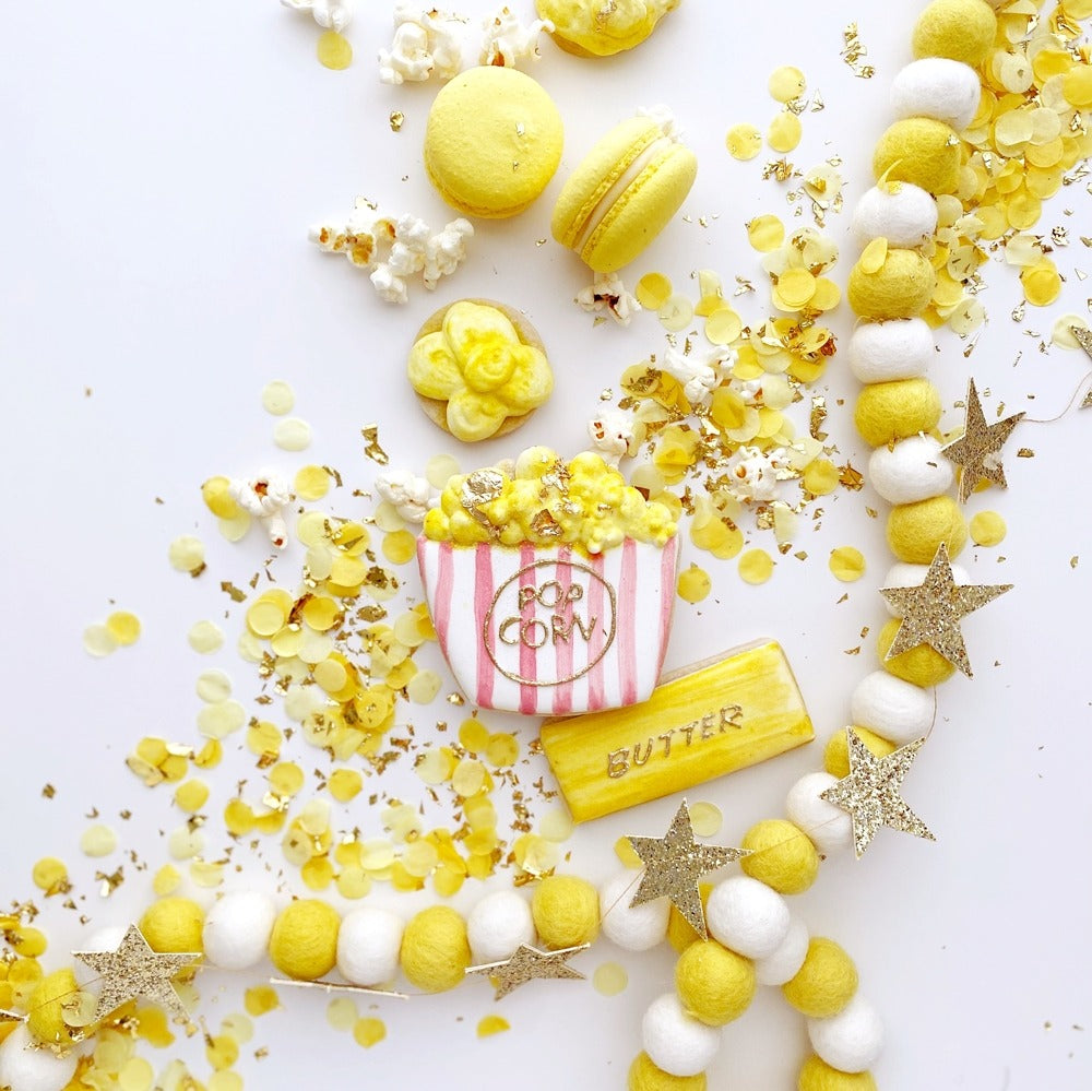 Yellow popcorn theme dessert and confetti decoration movie night birthday from Parte Haus party supply store in Bethesda MD