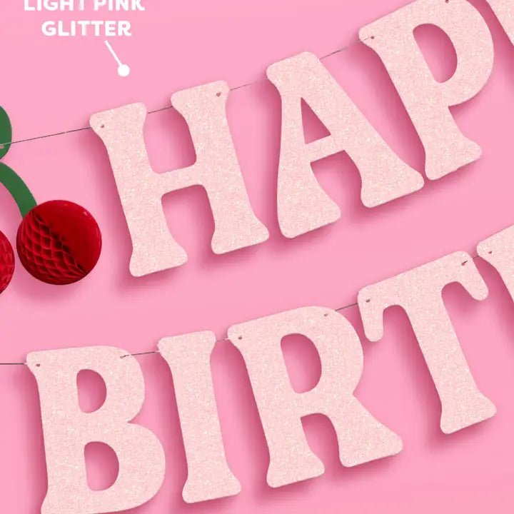 Light pink glitter birthday banner with bold letters for birthday from Parte Haus party supply store in Bethesda MD