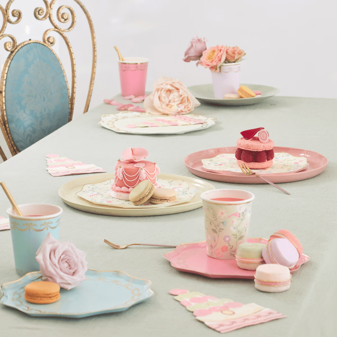 Pastel pink and blue tableware elegant tea party setup with macarons and roses Parisian theme from Parte Haus party supply store in Bethesda MD.