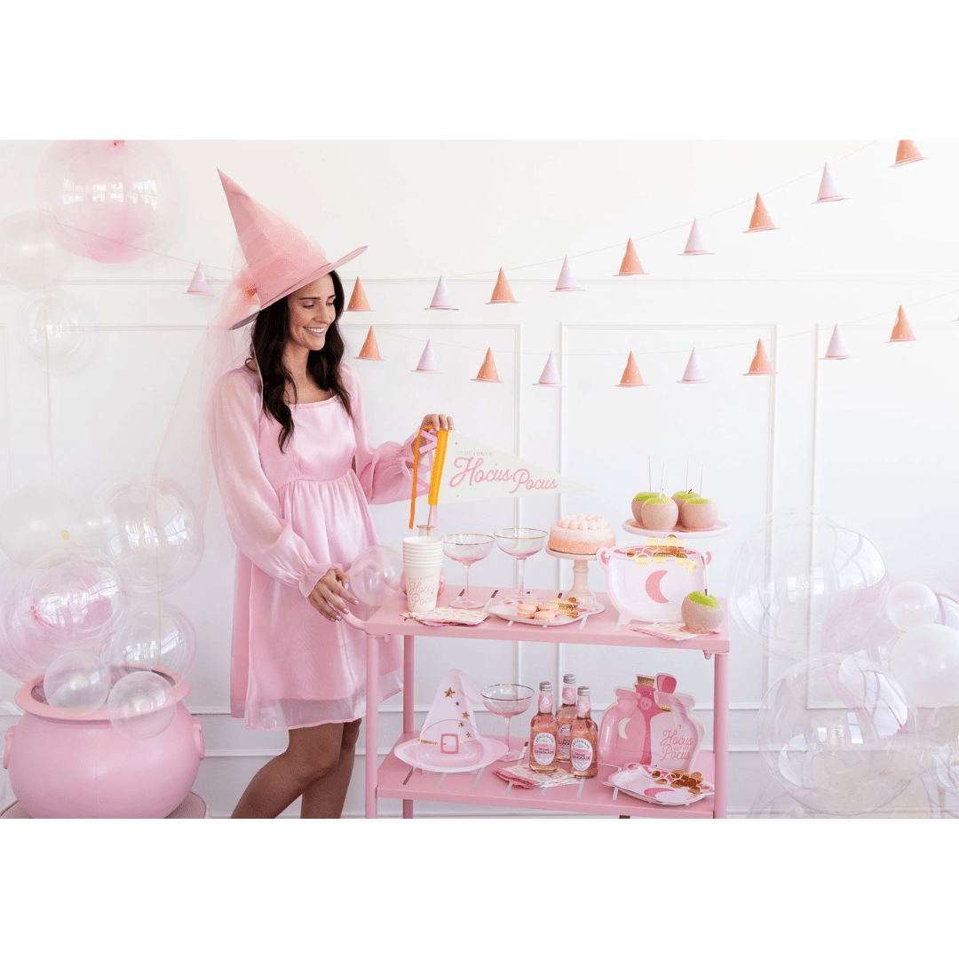Pink Halloween witch costume and pastel dessert table Halloween theme from Parte Haus party supply store in Bethesda MD