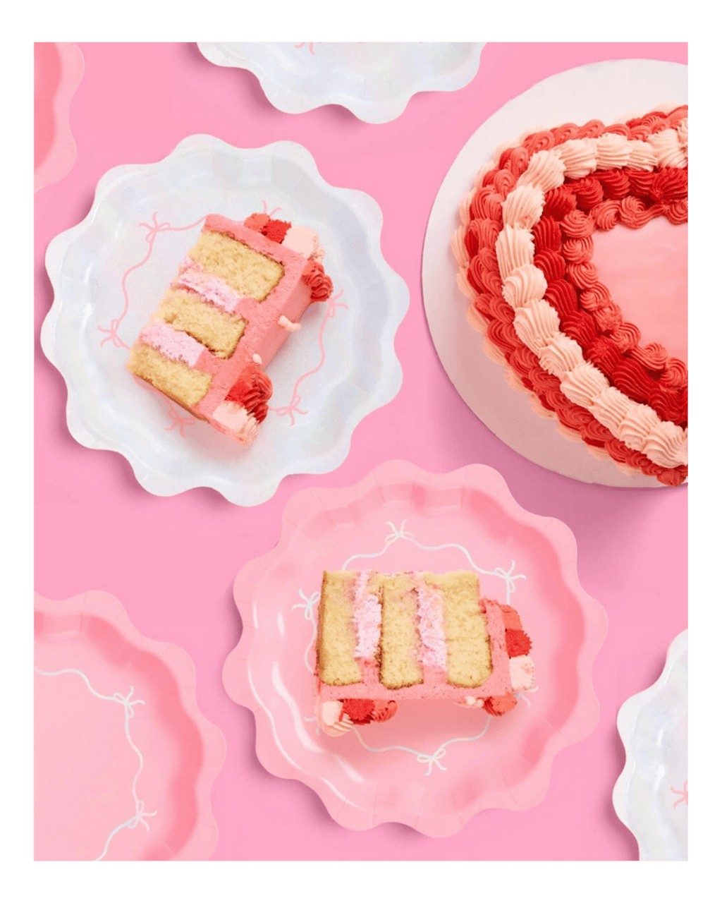 Pink heart shaped cake with swirl icing and matching scalloped plates for birthday theme from Parte Haus party supply store in Bethesda MD.