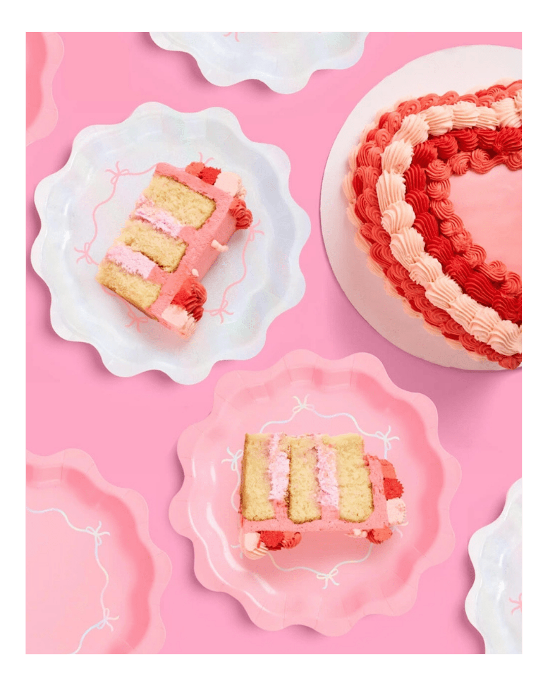 Pink heart shaped cake with swirl icing and matching scalloped plates for birthday theme from Parte Haus party supply store in Bethesda MD.