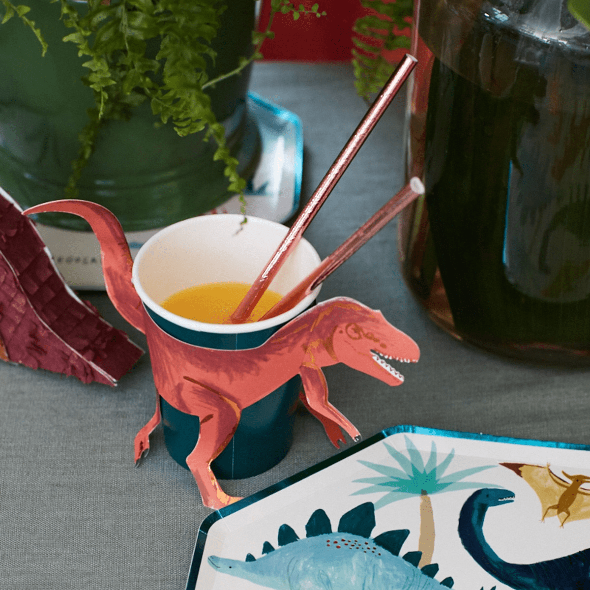 Red dinosaur themed paper cup with tail and legs perfect for kids birthday from Parte Haus party supply store in Bethesda MD