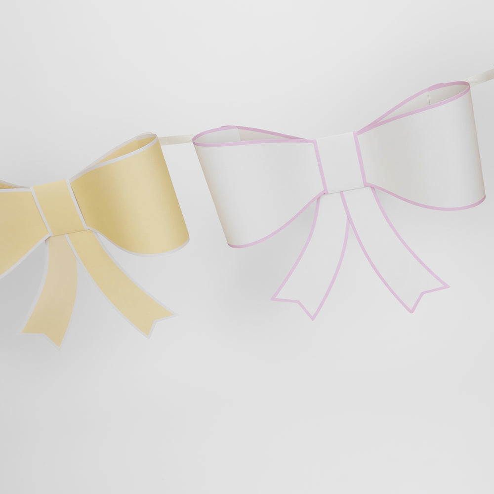 Pastel yellow and white bow garland banner for celebration theme from Parte Haus party supply store in Bethesda, MD.