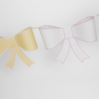 Pastel yellow and white bow garland banner for celebration theme from Parte Haus party supply store in Bethesda, MD.