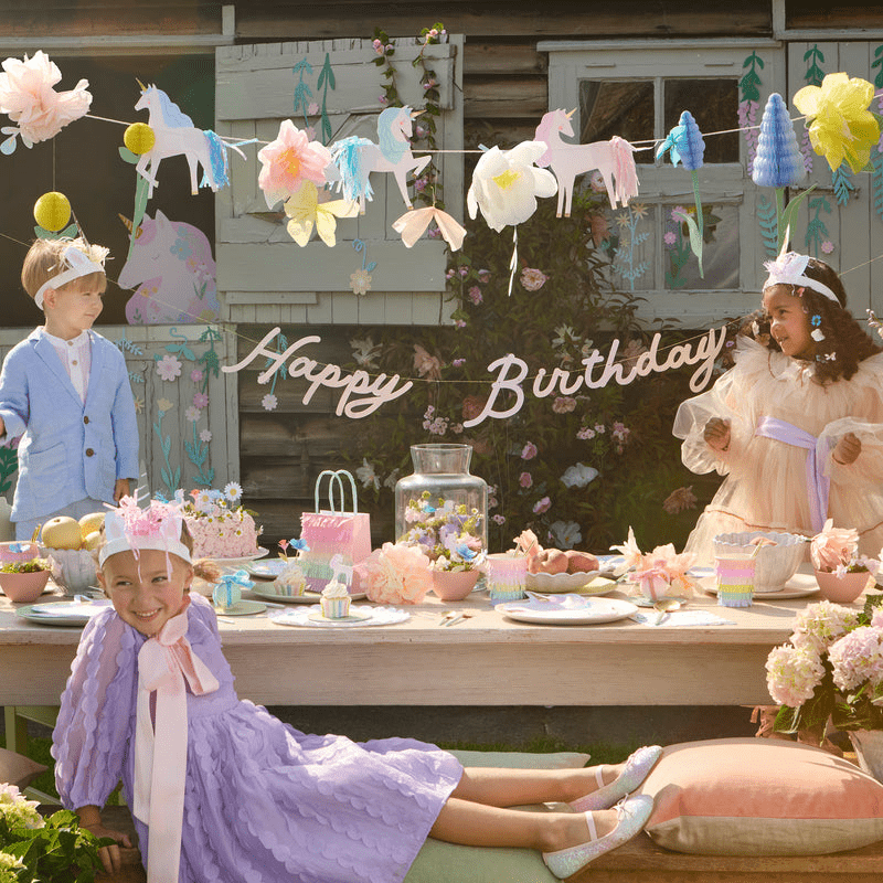 Pastel unicorn birthday banner pastel table decor and kids outdoor birthday theme from Parte Haus party supply store in Bethesda Maryland