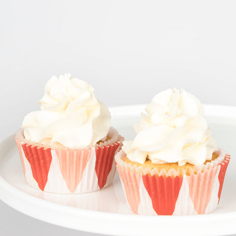 Red and white cupcake wrappers cupcake with white icing dessert for celebration from Parte Haus party supply store in Bethesda Maryland.