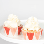 Red and white cupcake wrappers cupcake with white icing dessert for celebration from Parte Haus party supply store in Bethesda Maryland.
