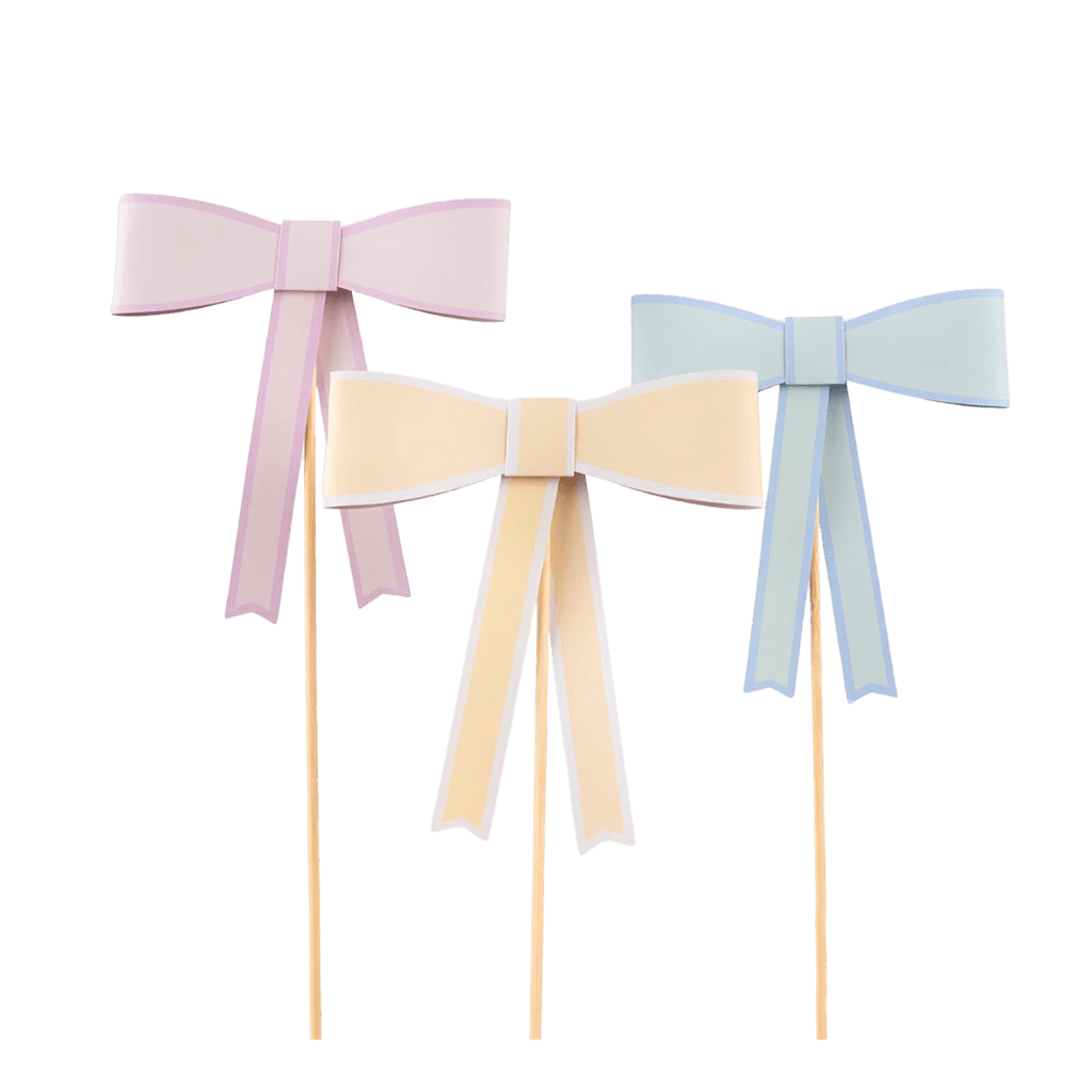 Pastel pink yellow and blue bow cake toppers for birthday from Parte Haus party supply store in Bethesda Maryland