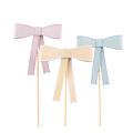 Pastel pink yellow and blue bow cake toppers for birthday from Parte Haus party supply store in Bethesda Maryland