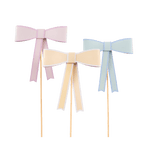 Pastel pink yellow and blue bow cake toppers for birthday from Parte Haus party supply store in Bethesda Maryland