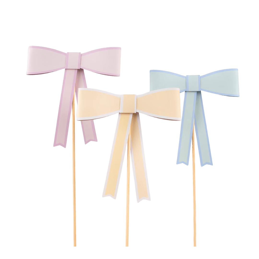Pastel pink yellow and blue bow cake toppers for birthday from Parte Haus party supply store in Bethesda Maryland