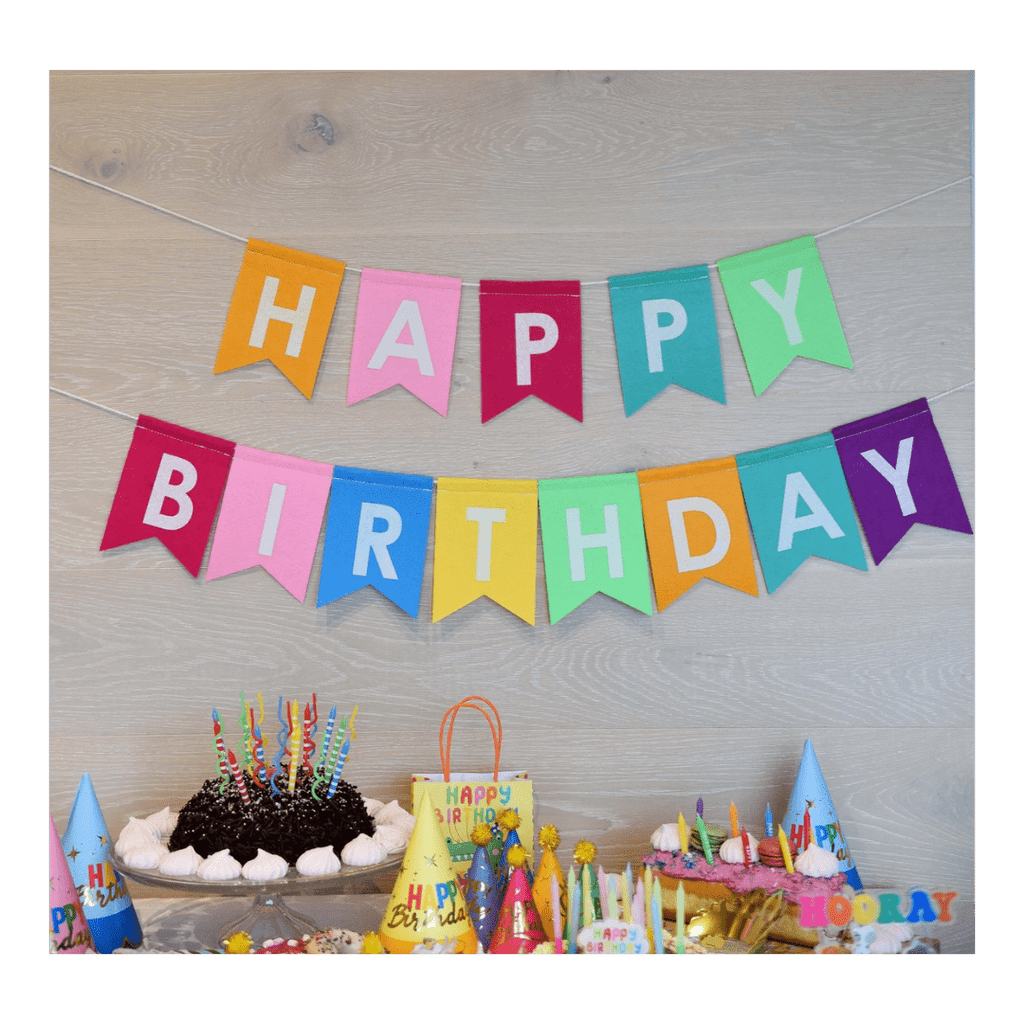 Multicolor birthday banner with bold letters and party hats birthday theme from Parte Haus party supply store in Bethesda MD.