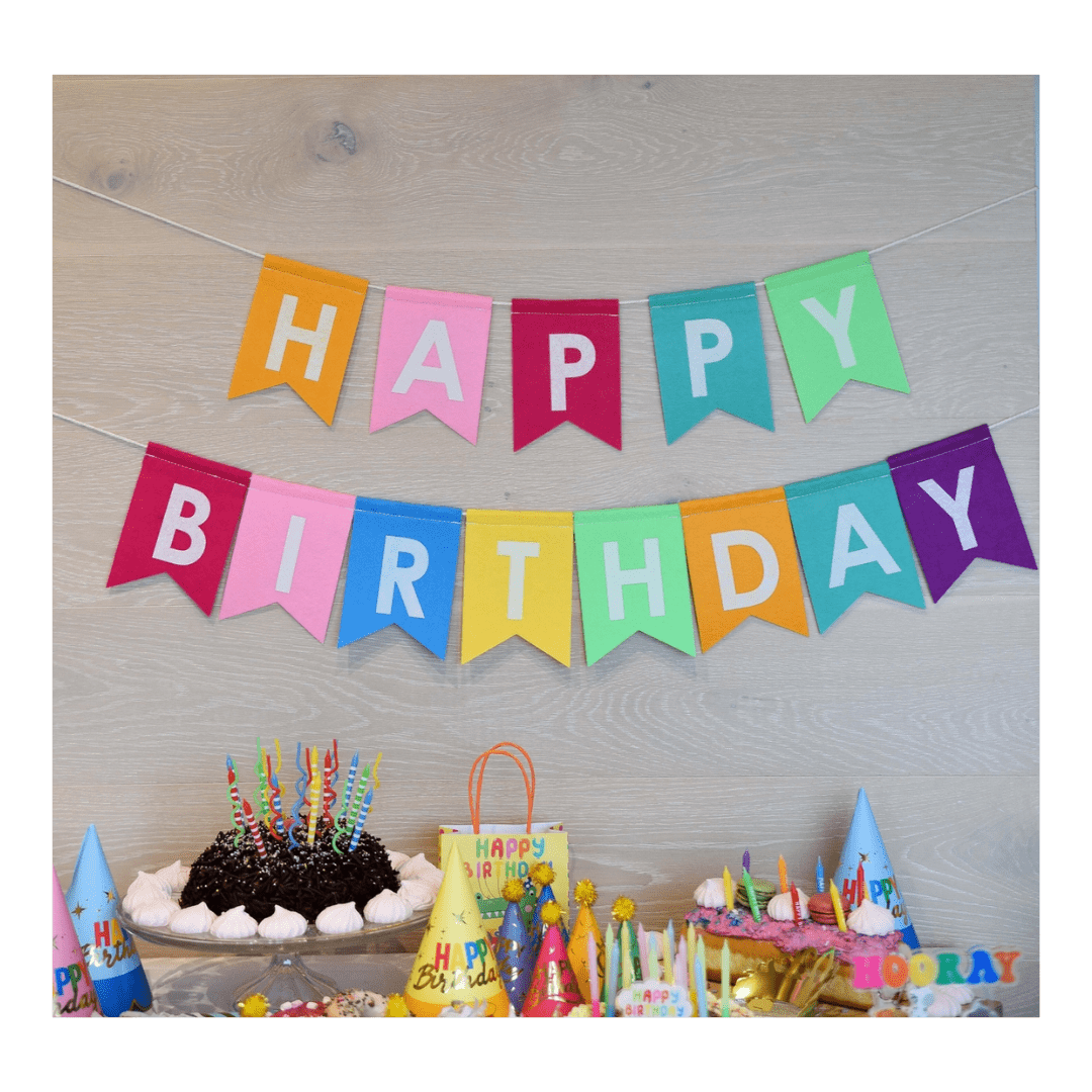 Multicolor birthday banner with bold letters and party hats birthday theme from Parte Haus party supply store in Bethesda MD.