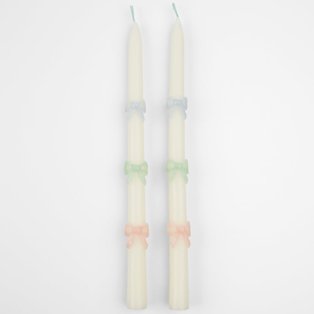 Pastel white taper candles with colored bows elegant celebration decor from Parte Haus party supply store in Bethesda Maryland