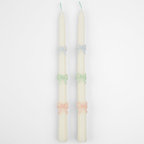 Pastel white taper candles with colored bows elegant celebration decor from Parte Haus party supply store in Bethesda Maryland