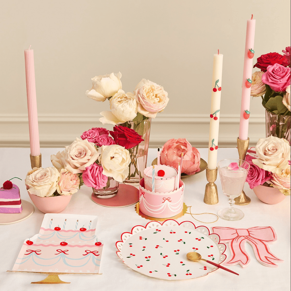 Pink birthday table setting with cherry cake plates and candles celebration theme from Parte Haus party supply store in Bethesda MD