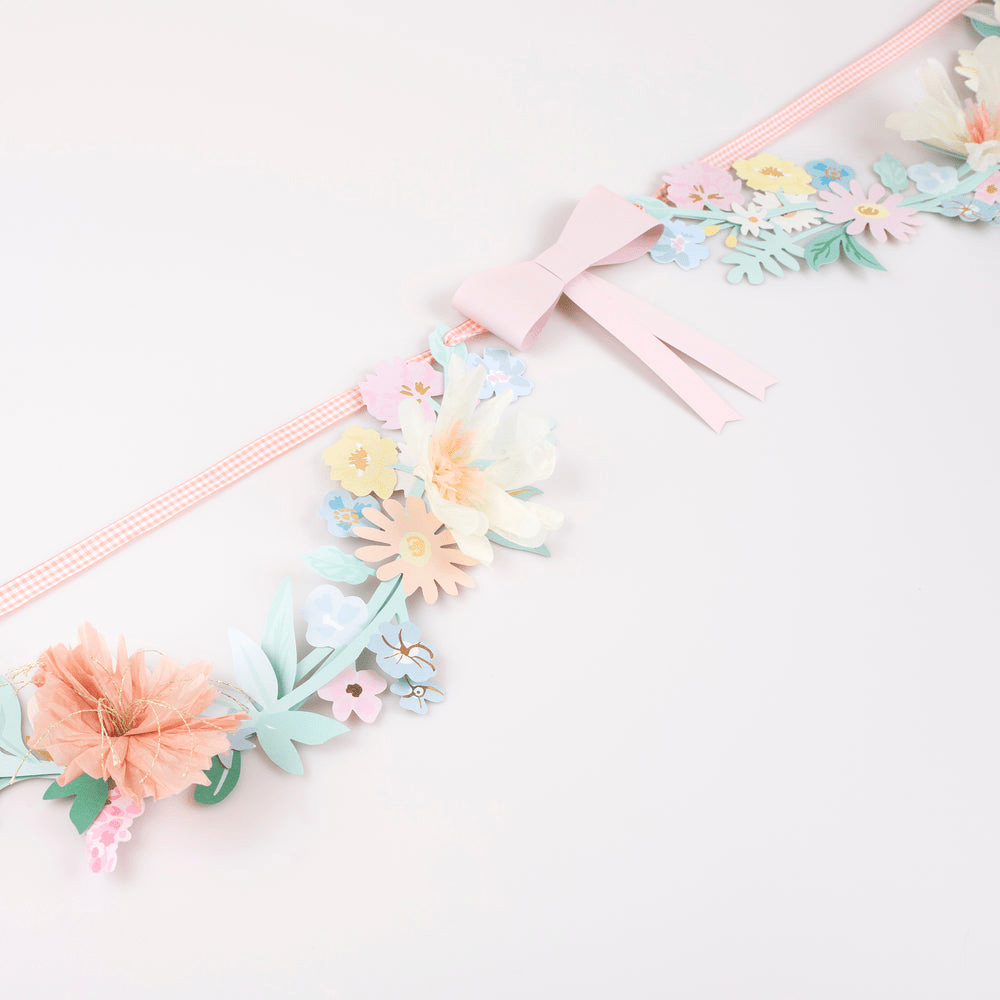 Pastel floral garland with paper flowers and pink bow spring theme from Parte Haus party supply store in Bethesda MD