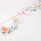 Pastel floral garland with paper flowers and pink bow spring theme from Parte Haus party supply store in Bethesda MD