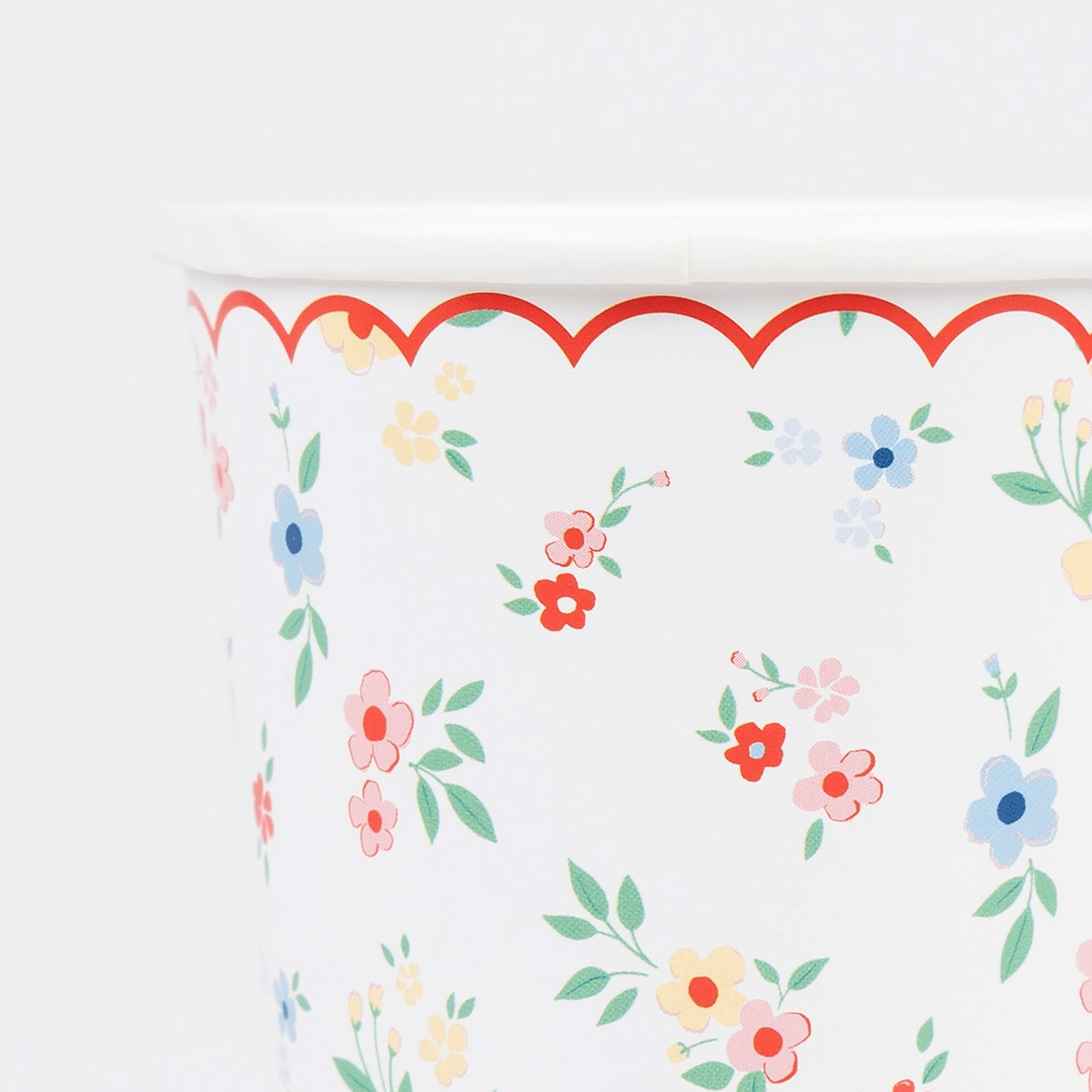 Multicolor floral paper cup with scalloped red edge for spring celebration from Parte Haus party supply store in Bethesda MD.