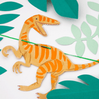 Orange dinosaur garland banner with green leaves jungle birthday from Parte Haus party supply store in Bethesda MD