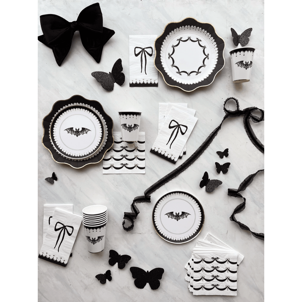 Black and white Halloween tableware with bat and bow designs gothic theme from Parte Haus party supply store in Bethesda MD
